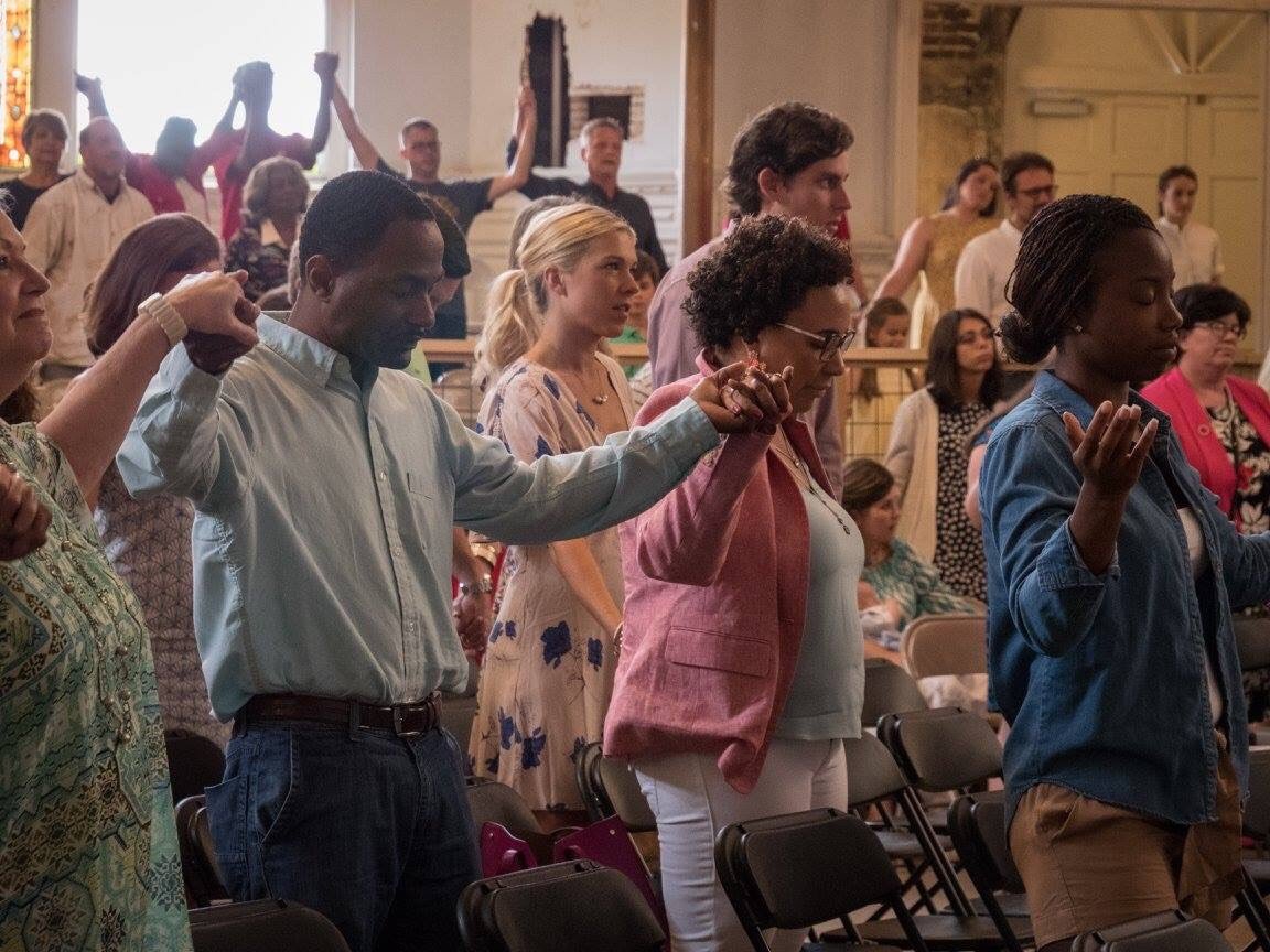 Diverse church congregation worshipping